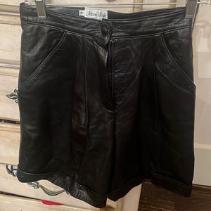 Black leather shorts. Pleated and lined. Size 8 above the knee. Adorable